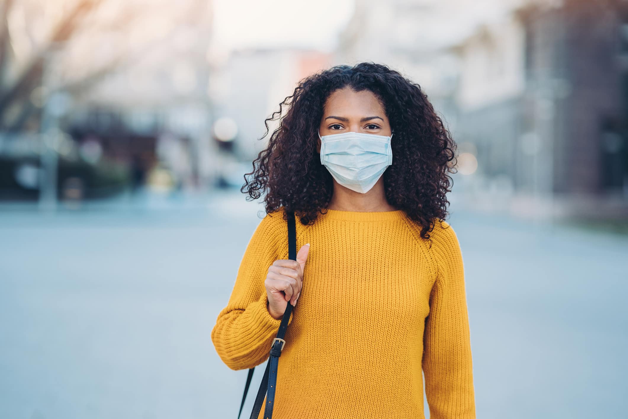 Woman standing with mask on